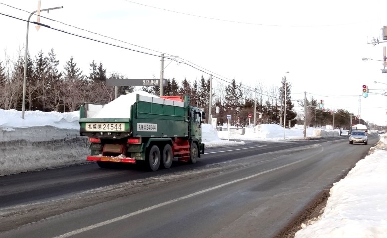 Truck clearing snow on Japanese road